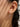 Close-up of a woman's ear showcasing Diamond Solitaire Silver Stud Earrings