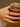 Close-up of a woman's finger showcasing Half Pavé Ring Set