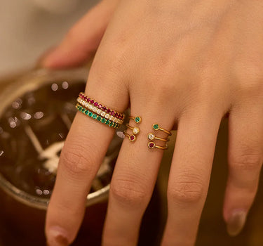 Close-up of a woman's finger showcasing Bezel Set Open Ring Set