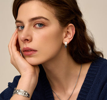 Close-up of a woman's neck showcasingBlackOnyxHuggieHoopEarrings