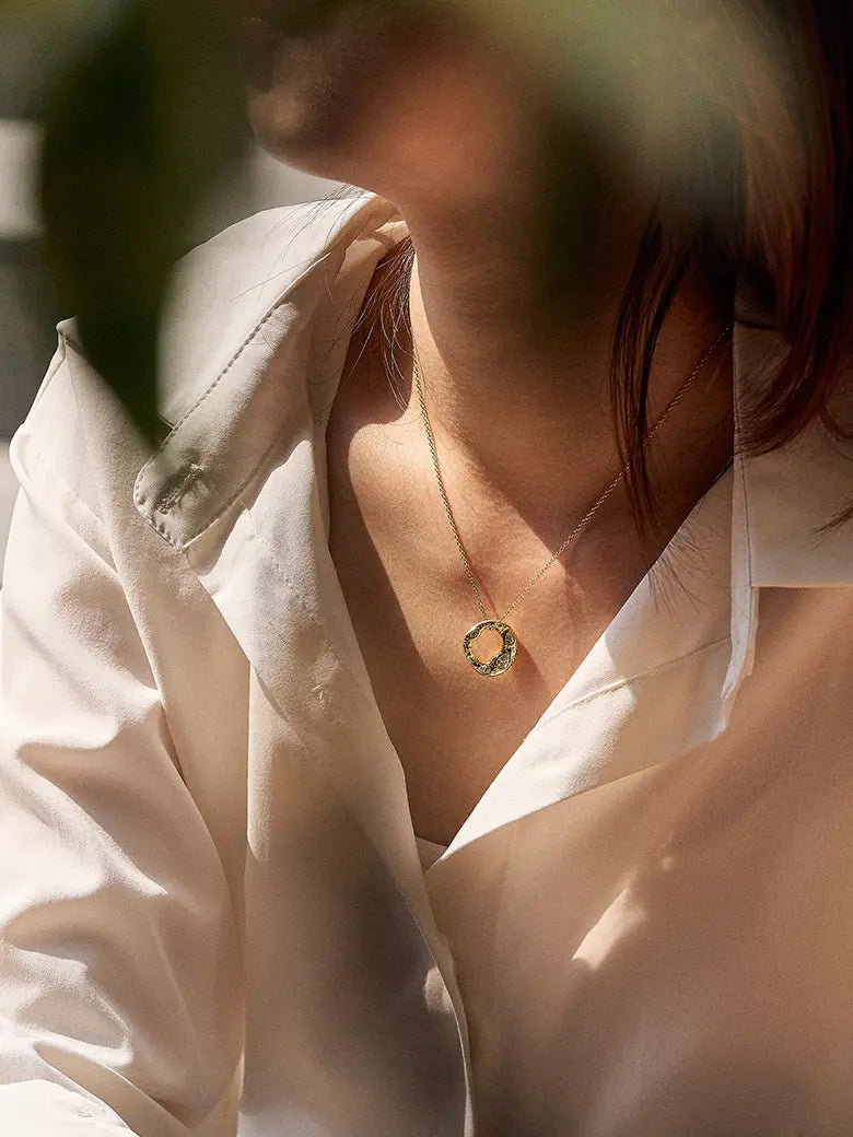 Close-up of a woman's neck showcasing CelestialHaloSilverNecklace