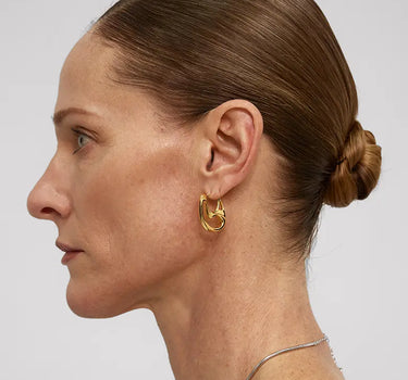 Profile view of a woman wearing Contour Hoops Earrings, showcasing their sleek and modern design.