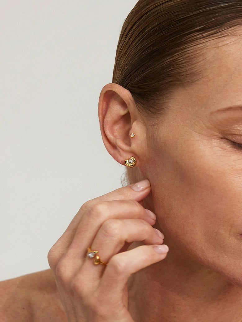 Close-up of a woman wearing Diamond Arc Stud Earrings, showcasing the elegant lab-grown diamonds.