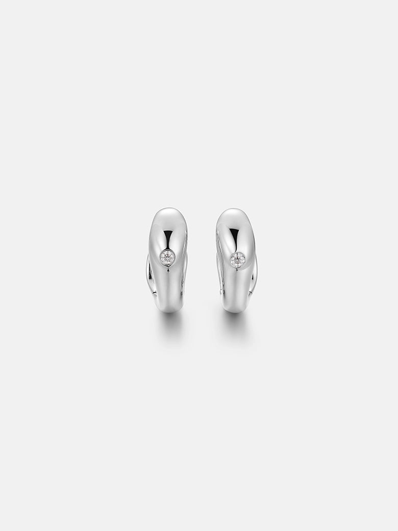Diamond dome silver earrings showcasing a polished minimalist design with a luxurious glow.