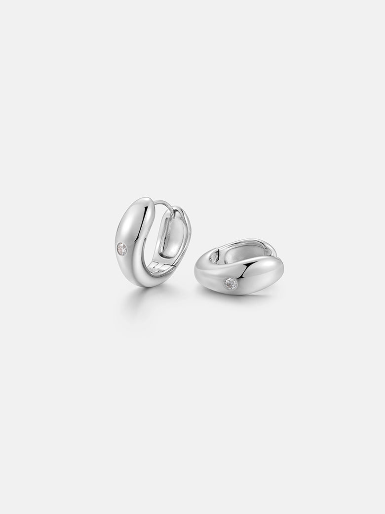 Elegant diamond dome silver earrings featuring a polished finish and minimalist design, capturing light beautifully.
