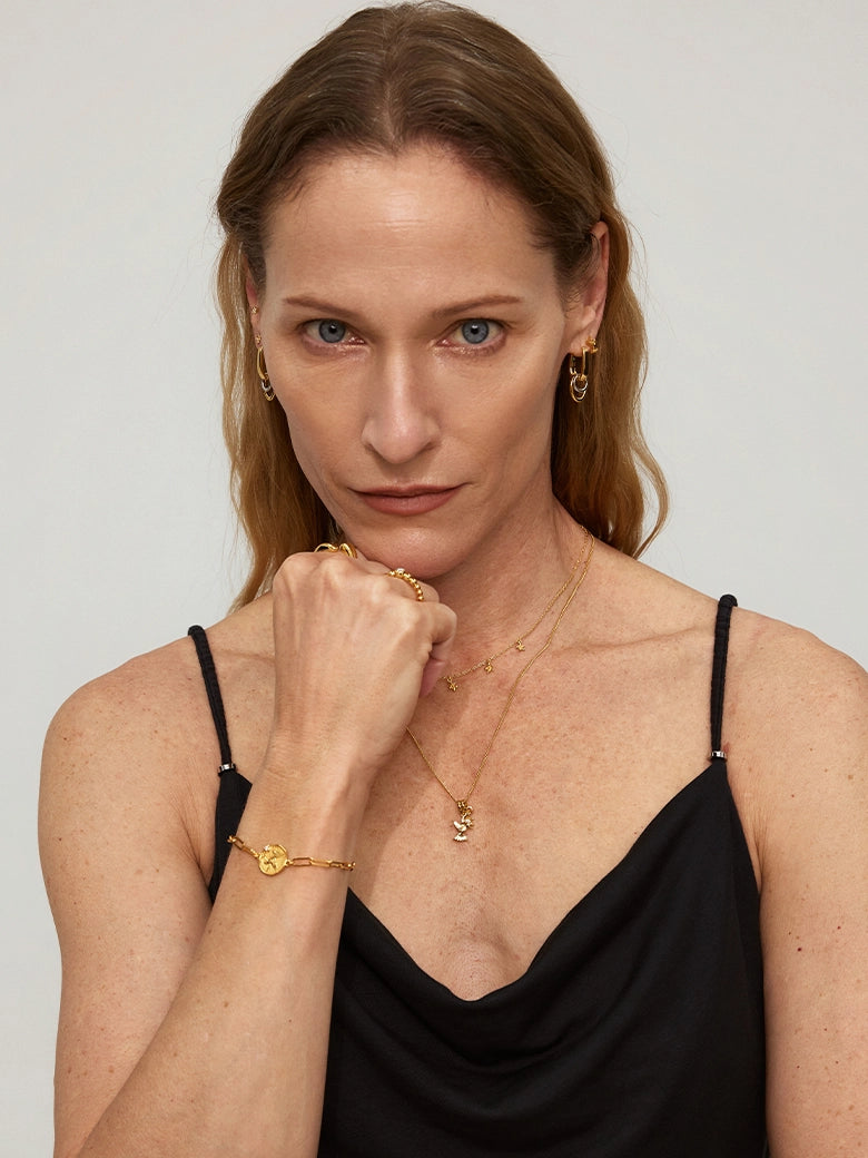 Close-up of a woman's wrist showcasing Diamond Dove Coin Bracelet
