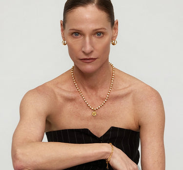Close-up of a woman's neck showcasing Diamond Dove Coin Pearl Necklace
