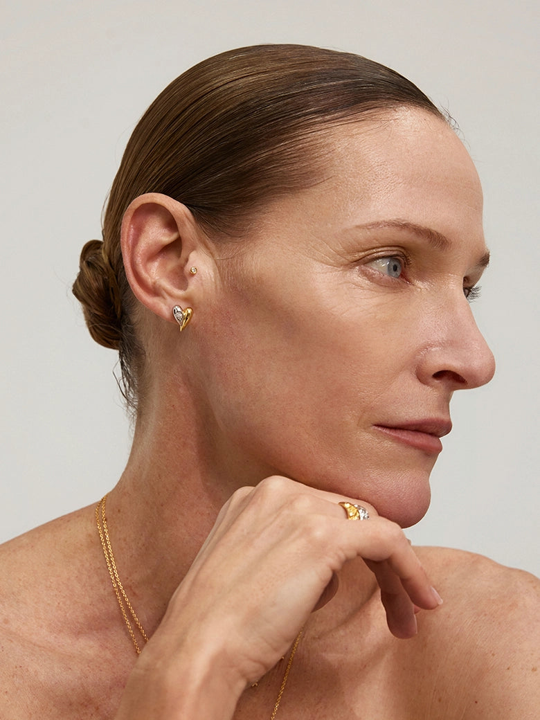 Close-up of a woman's neck showcasing DiamondDuoToneHeartStuds