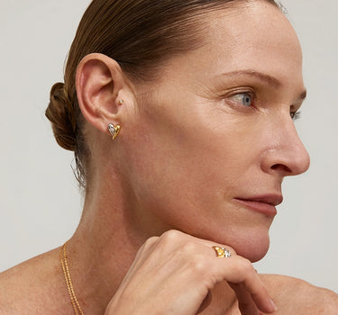 Close-up of a woman's neck showcasing DiamondDuoToneHeartStuds