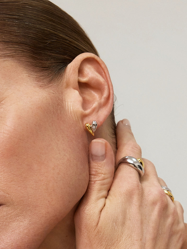 Close-up of a woman's neck showcasing DiamondDuoToneHeartStuds