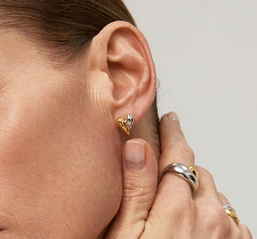 Close-up of a woman's neck showcasing DiamondDuoToneHeartStuds