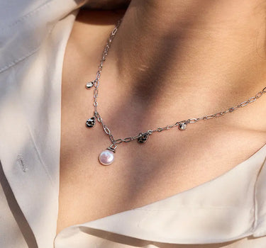 Close-up of a woman's neck showcasing Diamond Pearl Drop Silver Neckalce