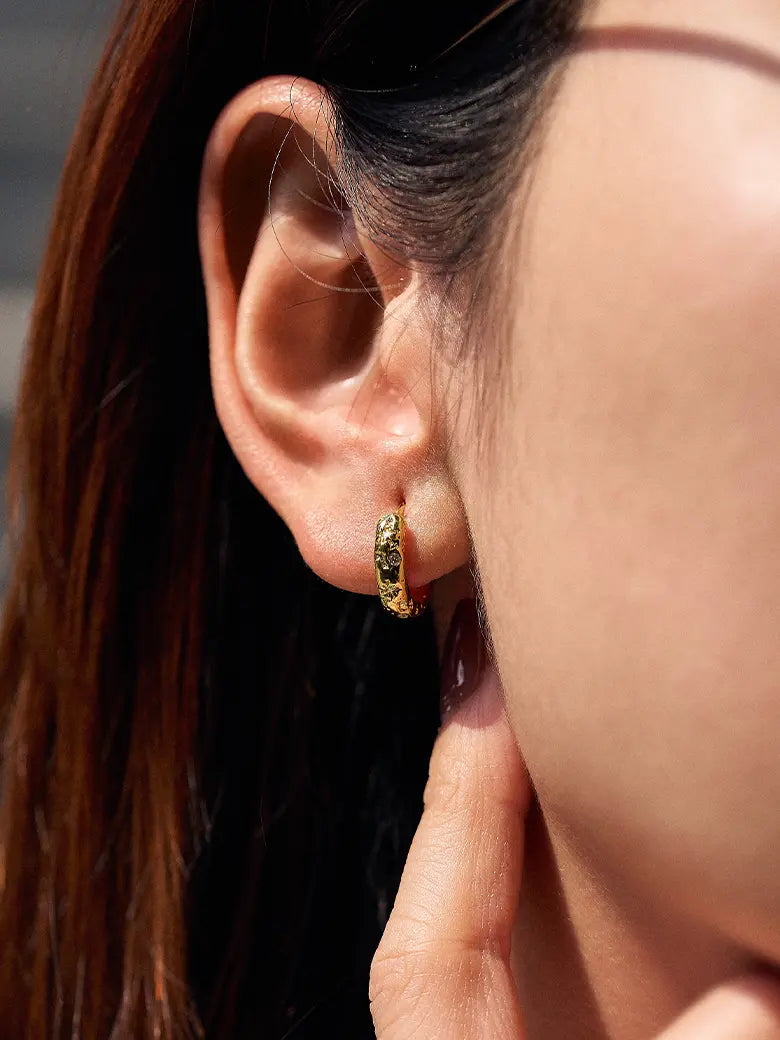 Close-up of a woman's ear showcasing Diamond Starlit Hoop Earrings