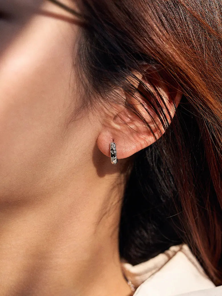 Close-up of a woman's ear showcasing Diamond Starlit Silver Hoop Earrings