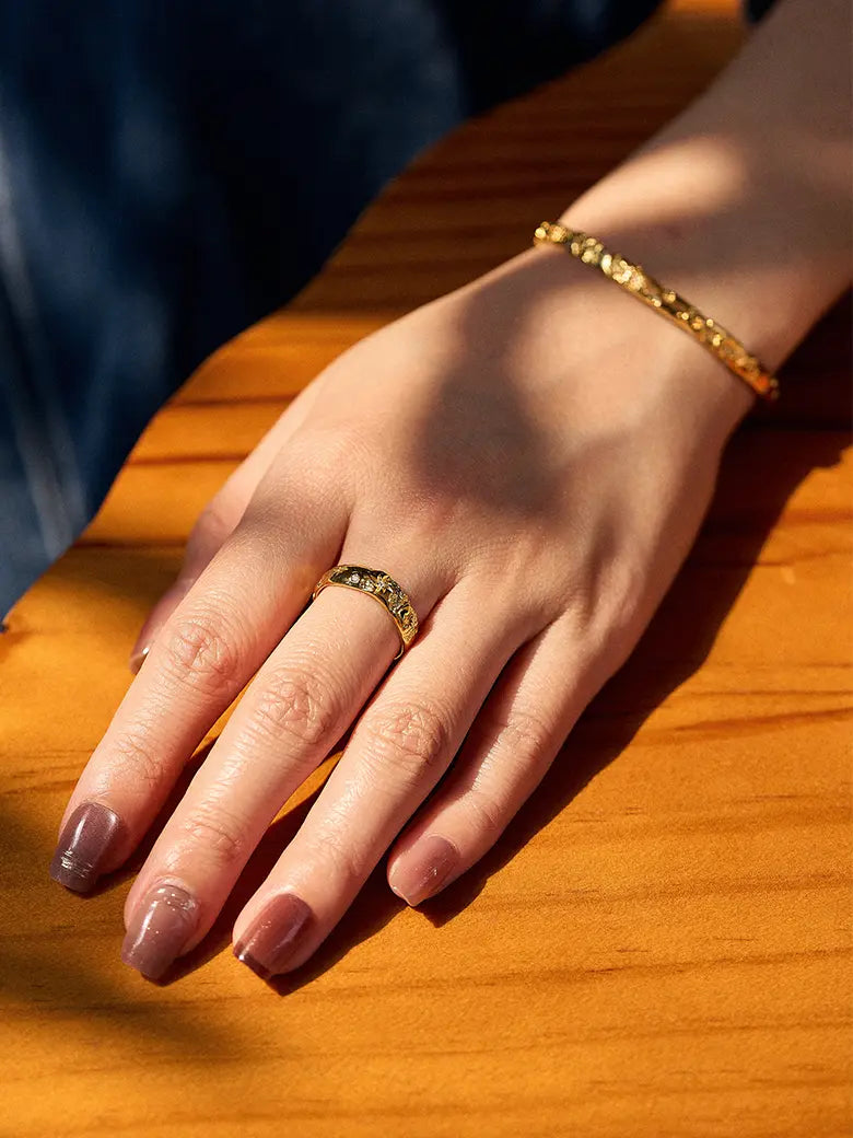 Close-up of a woman's finger showcasing Diamond Starlit Textured Ring