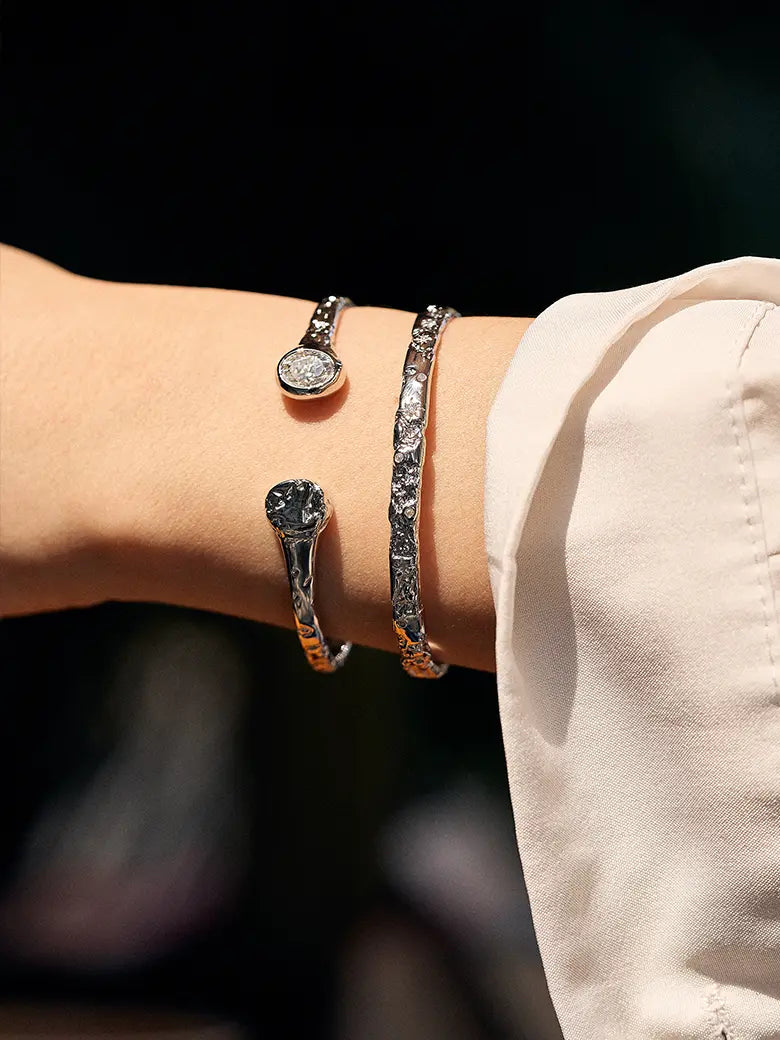 Close-up of a woman's wrist showcasing Diamond Starlit Textured Silver Bangle