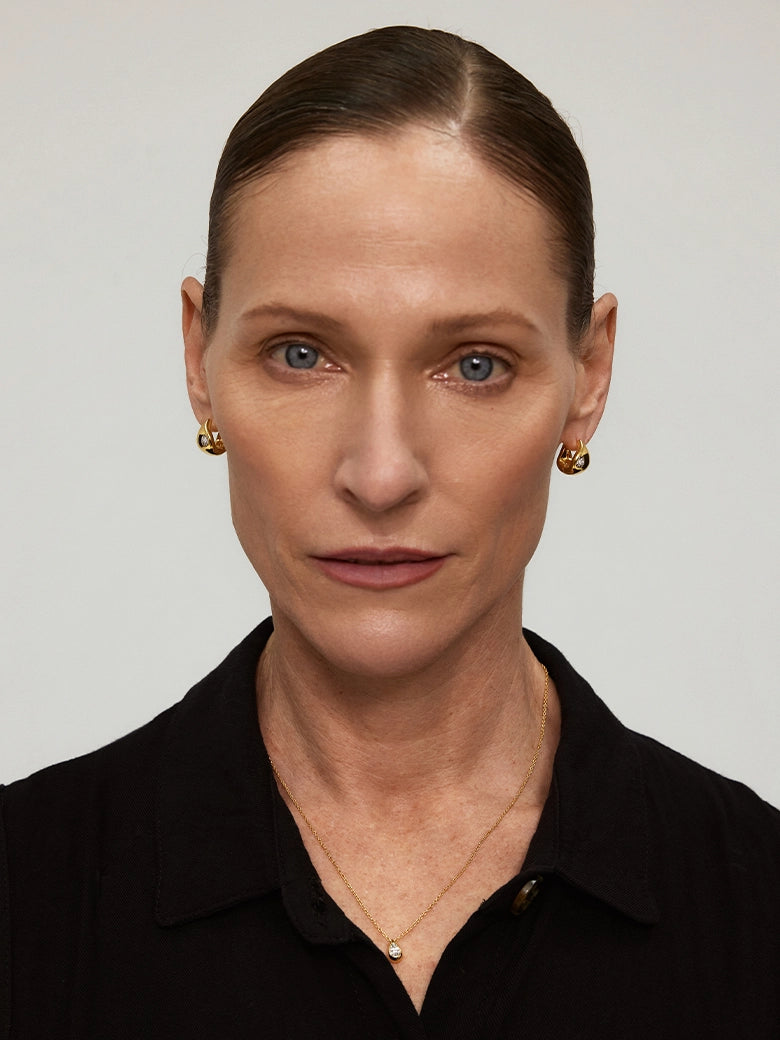 Close-up of a woman's neck showcasing DiamondTeardropHoopEarrings