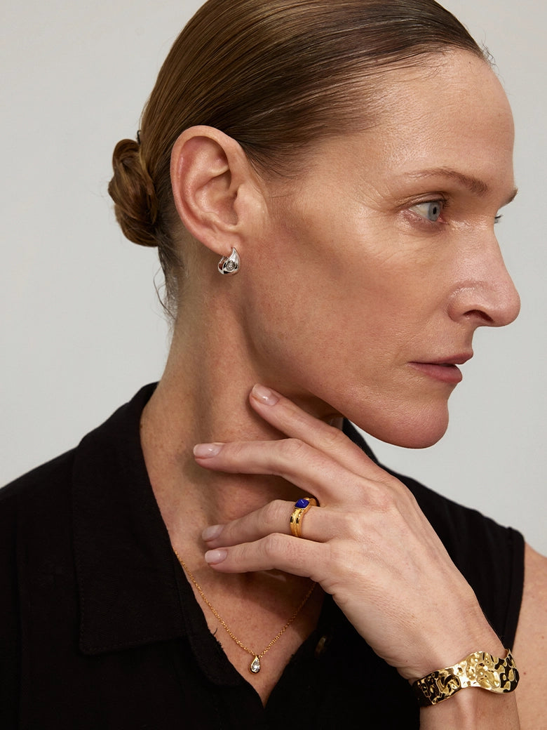 Close-up of a woman's neck showcasing DiamondTeardropSilverHoopEarrings