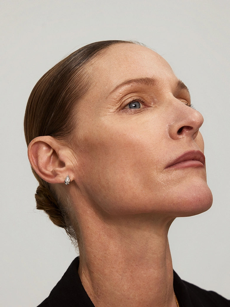 Close-up of a woman's ear showcasing Diamond Teardrop Silver Stud Earrings