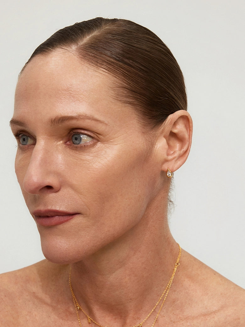 Close-up of a woman's neck showcasing DiamondTeardropStudEarrings