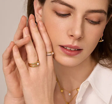Close-up of a woman's finger showcasing Double Hoop Pearl Stacking Ring