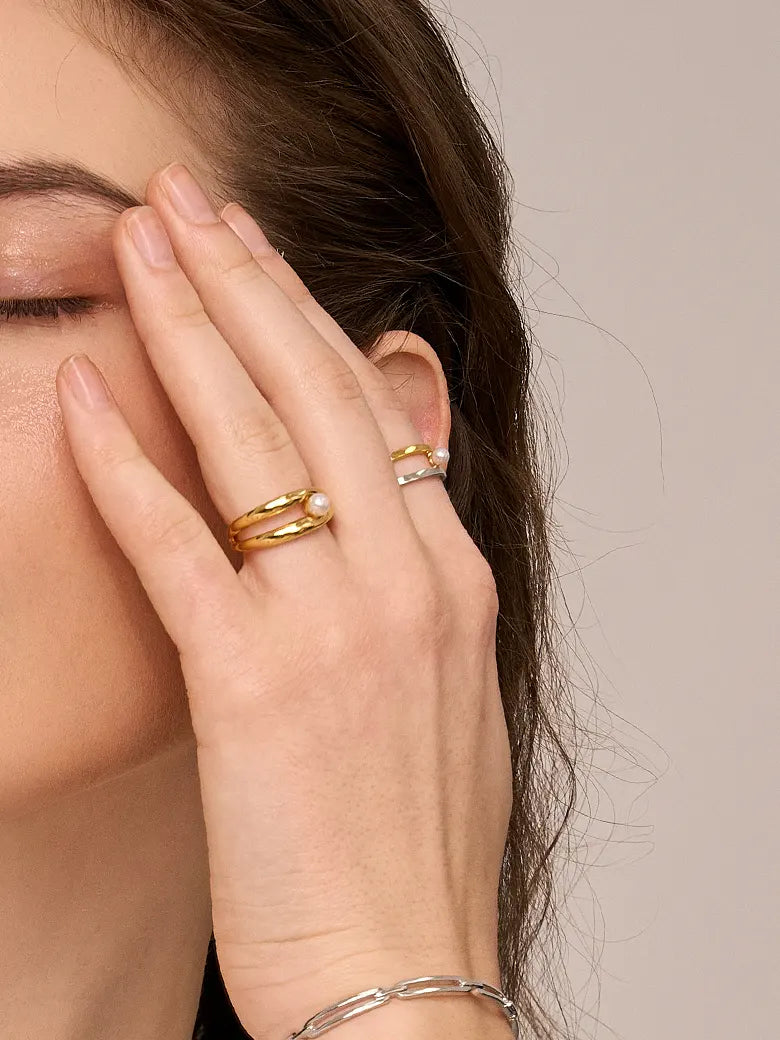 Close-up of a woman's finger showcasing Double Hoop Pearl Stacking Ring