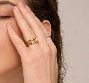 Close-up of a woman's finger showcasing Double Hoop Pearl Stacking Ring