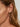 Close-up of a woman's ear showcasing Dove in Motion Stud Earrings