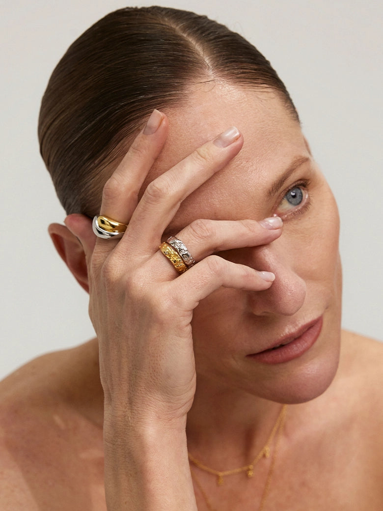 Close-up of a model wearing the Duo Dome Ring on her finger, showcasing its minimalist sculptural design.