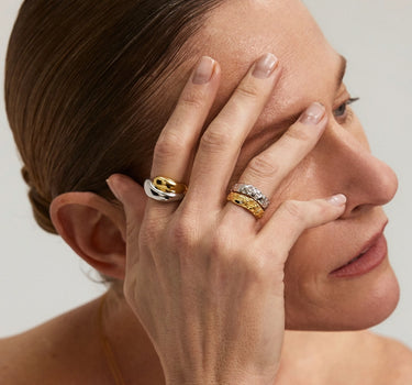 Close-up of a hand wearing the Duo Dome Ring alongside other rings, showcasing a minimalist jewelry aesthetic.