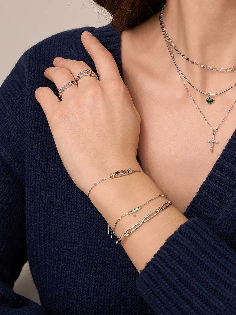 Close-up of a woman's wrist showcasing EmeraldSpheresSilverBracelet