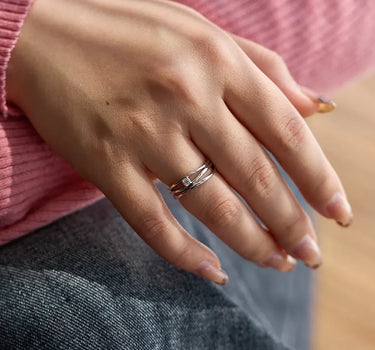 Close-up of a woman's finger showcasing Diamond Triple Silver Stacking Ring