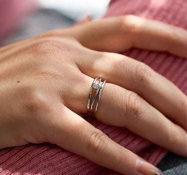 Close-up of a woman's finger showcasing Diamond Triple Silver Stacking Ring