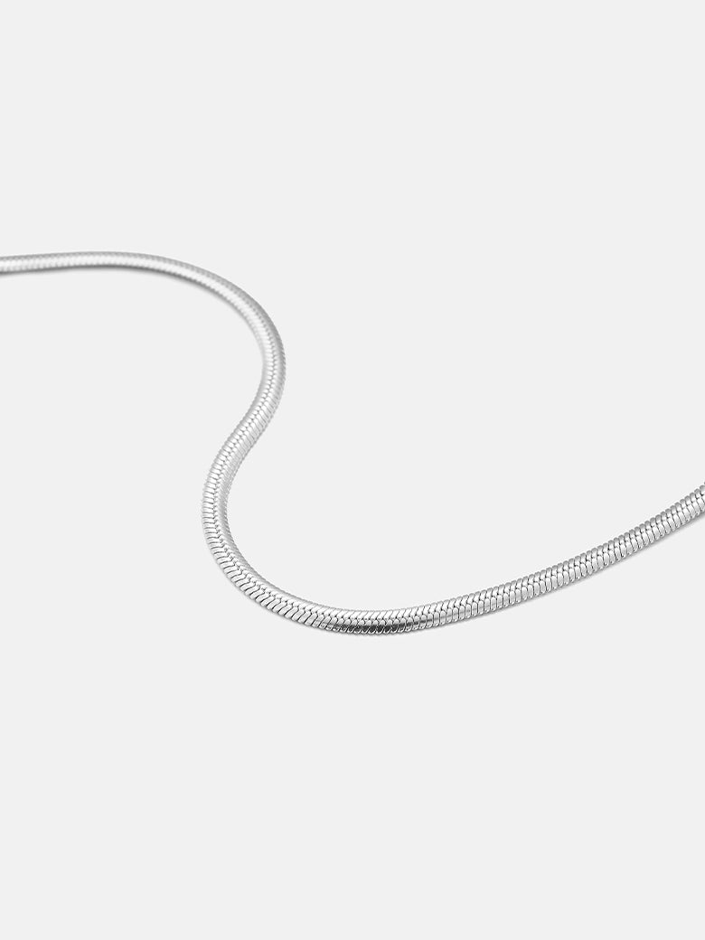Flat Snake Silver Bracelet on a light background showcasing its sleek and flexible design.