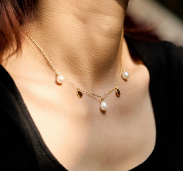 Close-up of a woman's neck showcasing FloatingPearlNecklace