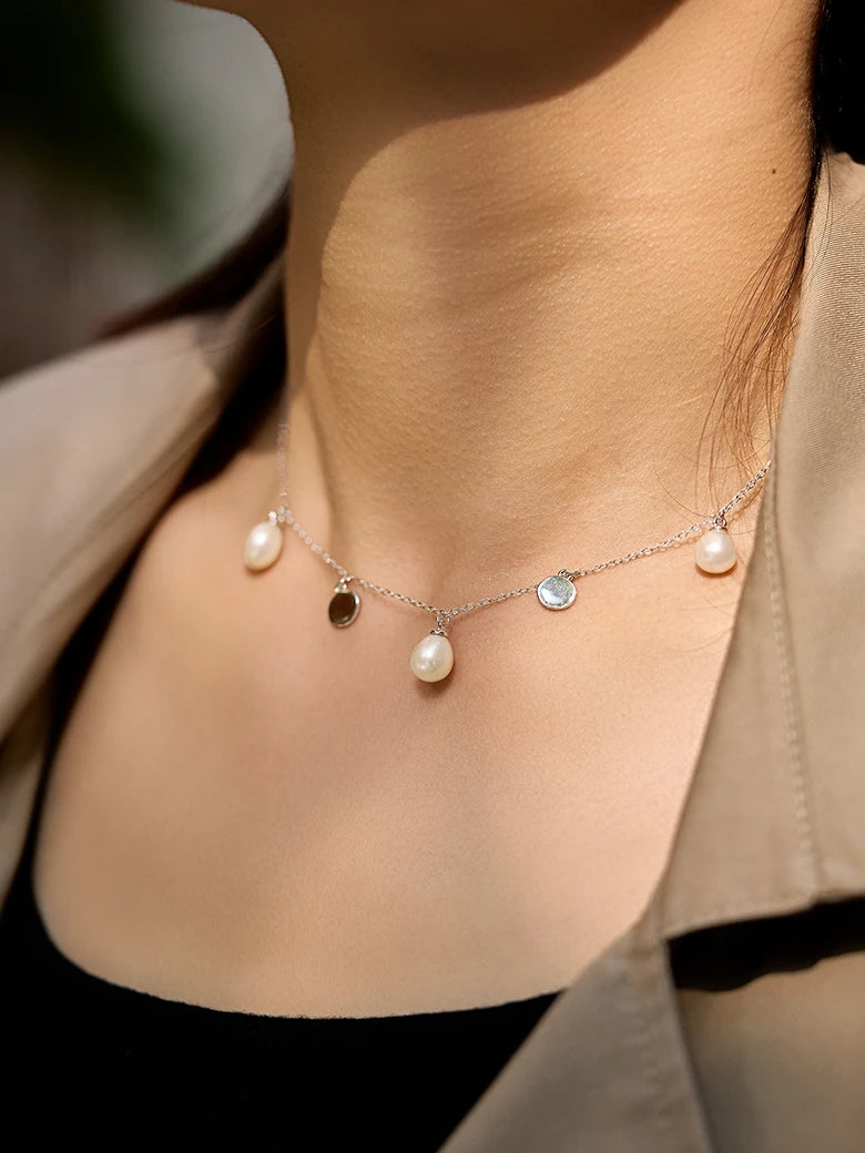 Close-up of a woman's neck showcasingFloatingPearlSilverNecklace