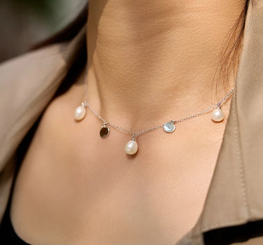 Close-up of a woman's neck showcasingFloatingPearlSilverNecklace