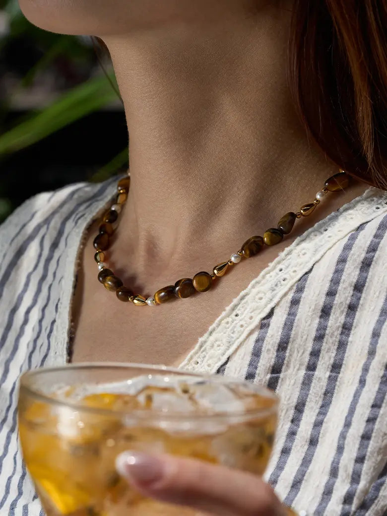 Close-up of a woman's neck showcasing GoldenTiger_sEyeBeadedNecklace