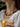 Close-up of a woman's neck showcasing GoldenTiger_sEyeBeadedNecklace