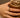 Close-up of a woman's finger showcasing Half Pavé Ring Set