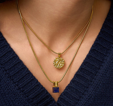 Close-up of a woman's neck showcasing
Lapis Lazuli Sanke Charm Necklace