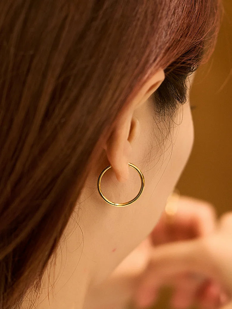 Close-up of a woman's ear showcasing Large Hoop Earrings