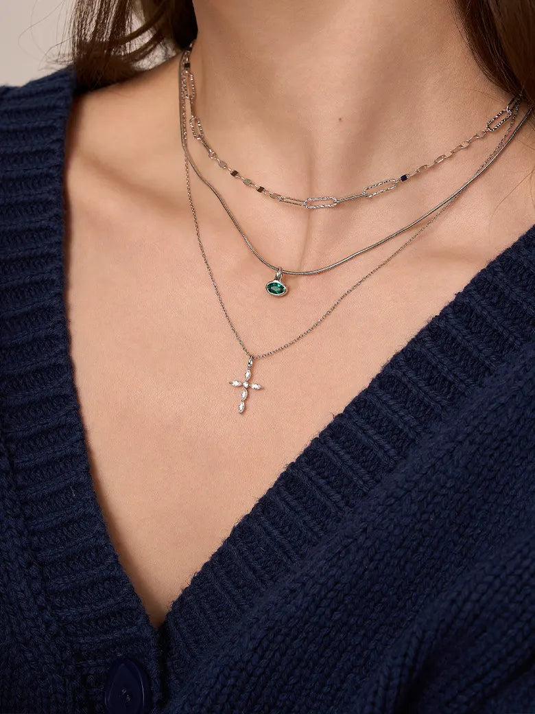 Close-up of a woman's neck showcasing  MarquiseCutMoissaniteCrossNecklace