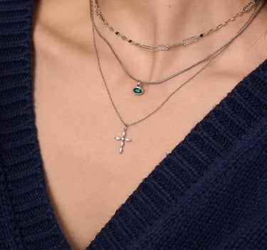 Close-up of a woman's neck showcasing  MarquiseCutMoissaniteCrossNecklace