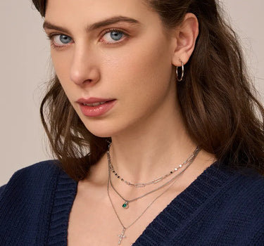 Close-up of a woman's neck showcasing  MarquiseCutMoissaniteCrossNecklace