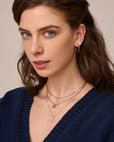 Close-up of a woman's neck showcasing  MarquiseCutMoissaniteCrossNecklace