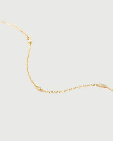 Mini Diamond Bezel Necklace featuring a delicate gold chain with bezel-set diamonds for elegance and sparkle.