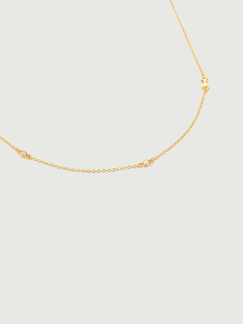 Mini Diamond Bezel Necklace featuring a delicate gold chain with bezel-set diamonds accenting the design.