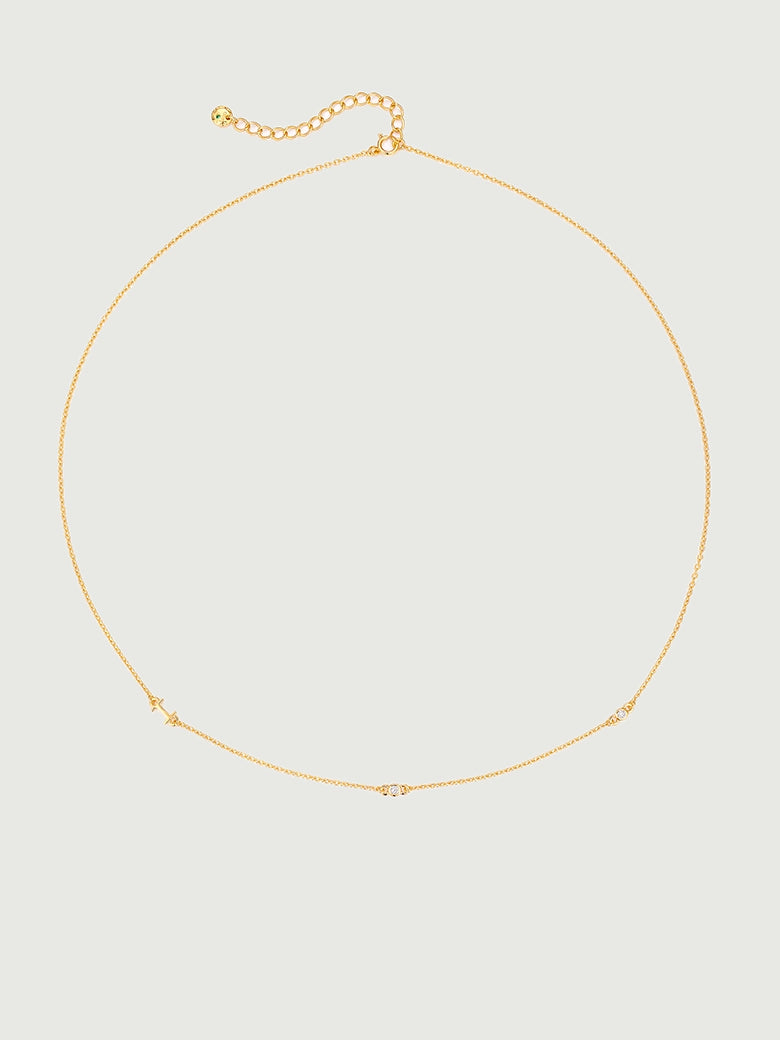 Mini Diamond Bezel Necklace featuring a delicate gold chain with bezel-set diamonds and moissanite stones.