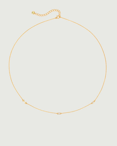 Mini Diamond Bezel Necklace featuring a delicate gold chain with bezel-set diamonds and moissanite stones.